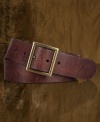 An antiqued trench buckle accents this worn and weathered leather belt for a vintage-inspired feel.