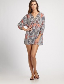 A print featuring muted colors and a touch of vibrant orange. The exotic beaded neckline completes this inspiring style.V-neckBeaded necklineThree-quarter elasticized sleevesPull-on styleLinenMachine washImported