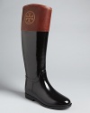 Tory Burch helps you take on wet weather in style in these equestrian-inspired rain boots featuring her signature, logo-centric style.