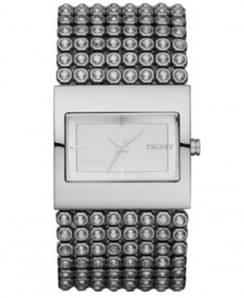 Bare your bling. This gorgeous DKNY watch features a crystal-accented stainless steel bracelet and rectangular case. Matte silvertone sunray dial with silvertone stick indices and logo. Quartz movement. Water resistant to 30 meters. Two-year limited warranty. Bare your bling. This gorgeous DKNY watch features a crystal-accented stainless steel bracelet and rectangular case. Matte silvertone sunray dial with silvertone stick indices and logo. Quartz movement. Water resistant to 30 meters. Two-year limited warranty.
