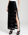 This GUESS maxi skirt flaunts a thigh-high slit and sheer stripes to reveal a hint of leg.