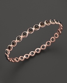 Smokey quartz stations dot a polished rosegold bangle from Ippolita. Smokey quartz stations dot a polished rosegold bangle from Ippolita.