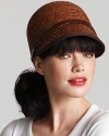 An equestrian style straw cap with pretty brown leather trim and buckle detail at side.