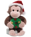 Curious George is ready to monkey around the Christmas tree, clutching a wreath and capped with a red and white Santa hat in this crazy-cute Gund plush toy.