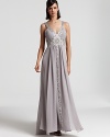 Make a glamorous entrance in this intricately beaded gown from Sue Wong. A plunging neckline adds sultry intrigue.