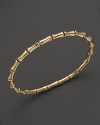 From the Bamboo Collection, a sleek bangle in 18k yellow gold. By Gucci.