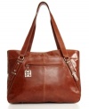 Corner-office chic: with sleek glazed leather and slanted dome-studded straps, the executive tote will have you climbing the corporate ladder in style.