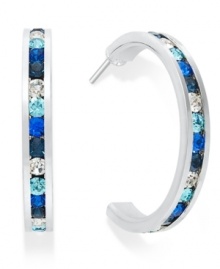 Traditions gives a sparkling boost to a simple pair of hoop earrings. A channel-set row of round-cut blue crystal with Swarovski elements shines within a sterling silver setting. Earrings feature a post and stud backing. Approximate diameter: 3/4 inch.