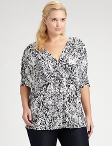 A distinctive abstract print on a stretchy, lightweight fabric has a flattering pleated crossover front and dolman sleeves for easy, draped shaping.V necklinePleated crossover bodiceElbow-length dolman sleevesStitched waistAbout 31 from shoulder to hemVenezia polyester/spandexDry cleanMade in USA