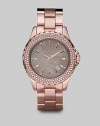 Add sparkle with a crystal bezel and a gray mother-of-pearl dial. Quartz movement Water-resistant to 10ATM Round rose goldplated stainless steel case, 42mm (1.65) Gray mother-of-pearl dial Index hour markers Date display between 4 and 5 o'clock Second hand Rose goldplated stainless steel link bracelet Imported 