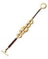 Trendy and textured. Hammered disks make a stylish statement on Lauren by Ralph Lauren's braided cord bracelet. Crafted in gold tone mixed metal, it includes a toggle closure. Approximate length: 7-1/2 inches.