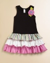 A colorful flower embellishment and contrasting ruffles make this pretty frock picture perfect.ScoopneckSleevelessPullover styleDrop-waistFull, ruffled skirt95% cotton/5% spandexMachine washImported
