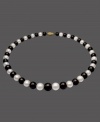The perfect picture of contrast. This necklace features a strand of alternating cultured freshwater pearls (8-12 mm) and onyx  beads (8-12 mm). Set in 14k gold. Approximate length: 18 inches.