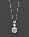 White gold bezel-set diamond necklace in three-stone drop design. With signature ruby accent. Designed by Roberto Coin.