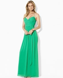 The sweeping glamour of a floor-skimming silhouette is captured in the elegant evening gown, rendered in beautifully pleated georgette with a feminine self-tie sash at the waist. The sweeping glamour of a floor-skimming silhouette is captured in the elegant evening gown, rendered in beautifully pleated georgette with a feminine self-tie sash at the waist.