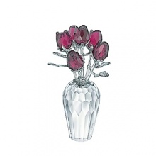 This wonderful vase in faceted clear crystal shows off six faceted rose blossoms in Ruby crystal. The silvertone metal details create magic in perfect harmony with the bright red flowers. This wonderful vase in faceted clear crystal shows off six faceted rose blossoms in Ruby crystal. The silvertone metal details create magic in perfect harmony with the bright red flowers.