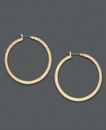 Lauren by Ralph Lauren adds sparkle to classic hoop earrings by turning them inside out and adding a layer of pave crystal. Crafted in goldtone mixed metal. Approximate diameter: 1-1/2 inches.