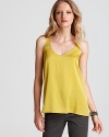 A citrus hue and flare silhouette marry for a memorable look from this Vince tank. Featuring a high/low hem, the stretch silk style elevates casual khakis from basic to brilliant.