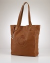 Crafted for chic versatility in sumptuous pebbled leather, the Putnum tote is finished with equestrian-inspired accents and an elegantly embossed crown crest for an iconic heritage look. From Lauren by Ralph Lauren.
