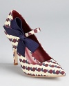 A sweet ribbon details these Tory Burch pumps, boasting a pointed toe and a pretty print.