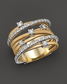 From the Goa collection, the banded ring with diamond accents on yellow and white gold, designed by Marco Bicego.