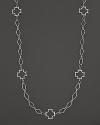 Sterling silver Maltese crosses punctuate a long chain. By Elizabeth Showers.