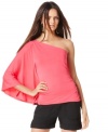 A swathe of fabric and a bare shoulder create plenty of dramatic flair! Balance INC's top with shorts or skinny capris.