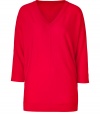 Paint bright color into your chic knitwear collection with DKNYs radiant red pullover - V-neckline, 3/4 sleeves, front and back seams, fine ribbed trim - Long, lean fit - Wear with favorite skinnies with sleek ankle boots