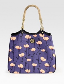 EXCLUSIVELY AT SAKS. Floral-printed canvas classic with a designer emblem, straw handles and smooth leather trim. Double straw top handles, 9 dropMagnetic snap closureOne inside zip pocketTwo inside open pocketsCotton lining13W X 12H X 6DImported
