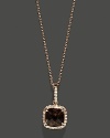 Diamonds frame a faceted smoky quartz, set in 14K rose gold.