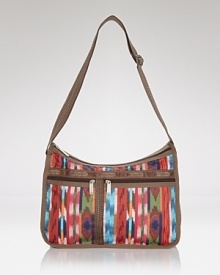 Ideal for the girl on the go, this versatile LeSportsac design features easy-access pockets and an adjustable strap - wear it over the shoulder or crossbody to keep hands free while holding it all. Ideal for the girl on the go, this versatile LeSportsac design features easy-access pockets and an adjustable strap - wear it over the shoulder or crossbody to keep hands free while holding it all.