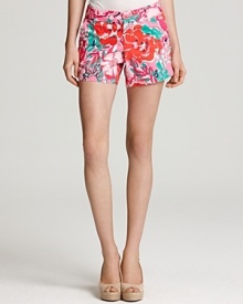 Bring a stylish tropical accent to your casual looks with pretty-in-pink printed shorts from Lily Pulitzer. Style with a scoop neck tee and nude wedges for elegant ease.