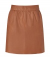 Stylish, lightly pleated skirt in supple, genuine leather - Chic, on-trend caramel color - Banded waist and back zip - Slim, flattering cut hits above the knee - Ideal for both day and evening - Go for a casual look with a white button down or cashmere pullover and ballet flats - Dress up with a silk top, blazer and platform booties