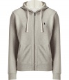 Sporty separates are casual wardrobe essentials, and this Polo Ralph Lauren light grey cotton fleece zip up has enduring appeal - Slim, straight cut - Classic hoodie style, with drawstrings, kangaroo pockets and full zipper - Banded waist and cuffs - Embroidered polo pony logo at chest - Easy and indispensable, perfect for pairing with jeans, chinos, shorts or sweatpants