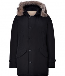 Designed by Yoshida Tokihito as a modern interpretation of the forever favorite Arctic parka, Woolrichs Polar parka is a must for contemporary cool weather looks - Hood with coyote fur trim, long sleeves, buttoned tabbed cuffs, hidden two-way front zip, button placket, buttoned front flap and slit pockets, tonal elbow patch detail - Contemporary fit, slightly fitted waist - A versatile, classic coat perfect for both city streets and country slopes