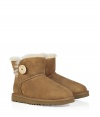 A stylish twist on a venerable classic, the Ugg Australia chestnut Mini Bailey Button boot is a welcome addition to your cold weather casual wardrobe - Crafted from twin-faced sheepskin and featuring exposed seams, reinforced heel, traction outsole and signature Ugg label - Wooden button and elastic band closure - Fleece-lined for superior warmth and comfort - Newer, ankle-length height - Truly versatile, perfect for pairing with everything from skinny jeans to yoga pants to miniskirts