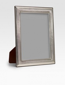 A stunning display for a treasured photo, crafted in subtly textured sterling silver. Accommodates a 8 X 10 photograph Imported