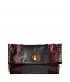 With leather and zebra-printed calf hair patchwork details and edgy stud embellishments, this Emilio Pucci clutch is a statement-maker - Leather and printed pony hair patchwork, front flap with logo turn-lock closure, studded side panels - Pair with leather leggings, an oversized blouse, and platforms