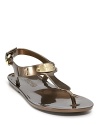 MICHAEL Michael Kors does the jelly shoe, executed in a sleek sandal silhouette with logo hardware and studded details.