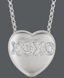 Say it from the heart. Sweethearts' adorable heart-shaped pendant expresses more that just great style with the letters XOXO written in round-cut diamonds (1/10 ct. t.w.) across the surface. Pendant crafted in sterling silver. Copyright © 2011 New England Confectionery Company. Approximate length: 16 inches + 2-inch extender. Approximate drop: 5/8 inch. Say it from the heart. Sweethearts' adorable heart-shaped pendant expresses more that just great style with the letters XOXO written in round-cut diamonds (1/10 ct. t.w.) across the surface. Pendant crafted in sterling silver. Copyright © 2011 New England Confectionery Company. Approximate length: 16 inches + 2-inch extender. Approximate drop: 5/8 inch.