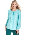 Scalloped trim and an unexpectedly chic color make this Charter Club blouse a fashion-forward choice for casual days.