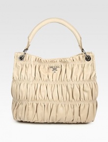 Ruched gaufre nappa leather crafted in a roomy top-handle carryall.Top handle, 6½ dropTop snap closureProtective metal feetOne inside zip pocketThree inside open pocketsPrada logo lining13½W X 11H X 6DMade in Italy Ruched gaufre nappa leather crafted in a roomy top-handle carryall.Top handle, 6½ dropTop snap closureProtective metal feetOne inside zip pocketThree inside open pocketsPrada logo lining13½W X 11H X 6DMade in Italy