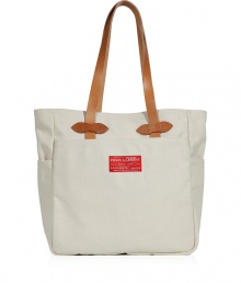 Tote around your everyday essentials in style with this luxe carryall from Filson - Solid canvas with leather trim, leather carrying handles, front and back pockets, water resistant - Perfect for the beach or travel Tote around your everyday essentials in style with this luxe carryall from Filson - Solid canvas with leather trim, leather carrying handles, front and back pockets, water resistant - Perfect for the beach or travel