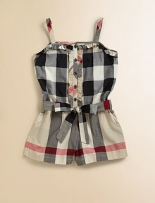A classic one-piece romper is given a luxe update with a sweet ruffle trim, tie waist and the requisite check print.Straight necklineSlender strapsFront button placket with ruffle trimBelted waistSide slash pocketsCottonMachine washImported Please note: Number of buttons may vary depending on size ordered. 