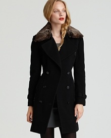 Warmth has never looked so sophisticated in this chic double breasted coat by Marc New York. A supple fur collar lends luxury to this iconic belted silhouette.