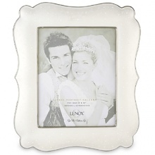 Opal Innocence, the popular china pattern from Lenox, lends a romantic feel to this fine china frame. Here, pearl-like enamel dots are elegant against an opalescent background. The frame, trimmed in precious platinum, makes a perfect engagement or wedding gift. Frame is crafted of Lenox white bone china accented with precious platinum and holds one 8 x 10 photo.Height: 14 1/2 Opal Innocence, the popular china pattern from Lenox, lends a romantic feel to this fine china frame. Here, pearl-like enamel dots are elegant against an opalescent background. The frame, trimmed in precious platinum, makes a perfect engagement or wedding gift. Frame is crafted of Lenox white bone china accented with precious platinum and holds one 8 x 10 photo.Height: 14 1/2