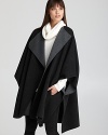 Modern, sophisticated and cool, this voluminous Vince cape delivers laid-back luxury.