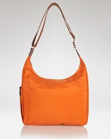 Longchamp's nylon hobo is a fuss-free take on a classic shape. Carry the pretty-practical style to add an enviable dose of Parisian chic to everyday looks. Longchamp's nylon hobo is a fuss-free take on a classic shape. Carry the pretty-practical style to add an enviable dose of Parisian chic to everyday looks.