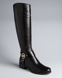 MICHAEL Michael Kors finishes off these riding boots with bold logo plate harness details that spell stylish. MICHAEL Michael Kors finishes off these riding boots with bold logo plate harness details that spell stylish.