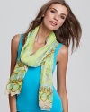 Add an elegant touch to your favorite ensemble with bright printed scarf from Theodora & Callum.